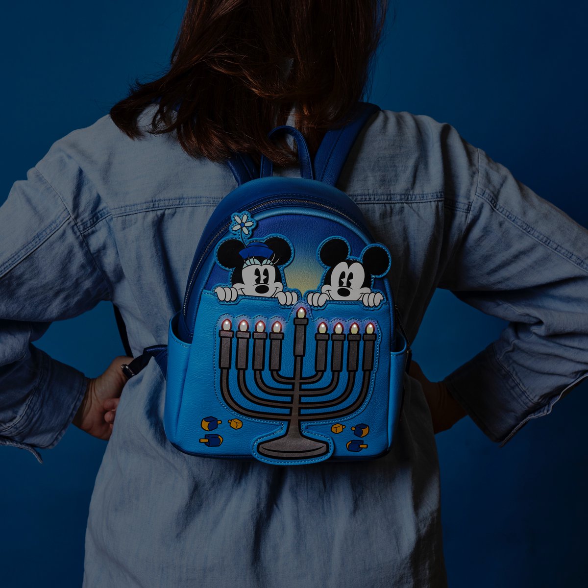 Loungefly's tweet photo. We're #HalfwaytotheHolidays and so excited to share our new @DisneyParks exclusive Hanukkah backpack coming this holiday season (and yes, it lights up one per night!). 
https://t.co/FSvTKh4px4
Stay tuned for more holiday #Loungefly styles coming later this year! https://t.co/XmTKJSGD0W