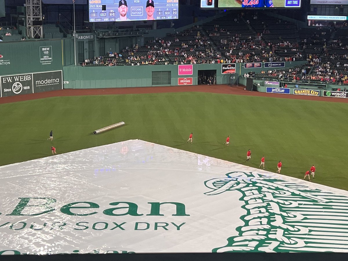 Fenway grounds crew out on the field as the (soaking wet) crowd goes wild.  Baseball on the horizon!  #redsox #fenwayweather