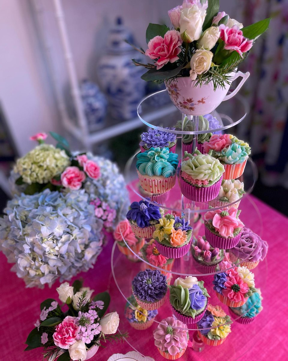 A tiered stand filled with cupcakes with beautiful buttercream flowers and topped with a charming floral arrangement creates a pretty teatime for Delectable by Design. Using teacups as a vessel for flowers is a clever way to incorporate tea into every aspect of your gathering.
