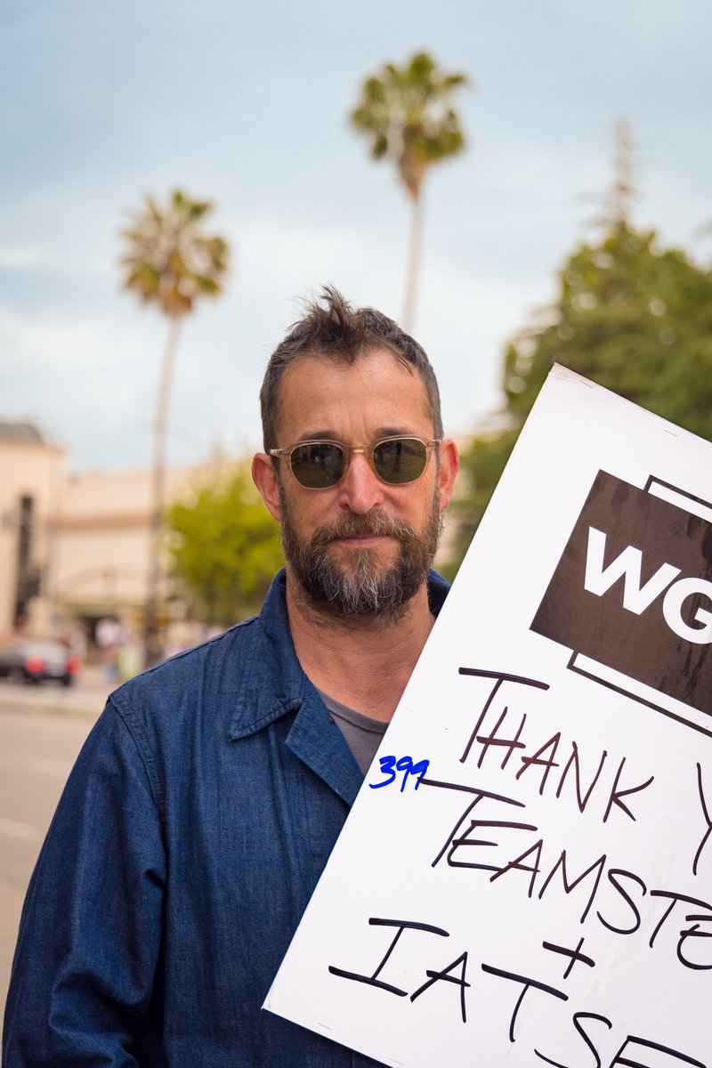 Meet actor Noah Wyle, John Carter in ER. Why he's striking: I'm a triple card holder, and I'm out here to show the commonality between all the unions and to promote collective bargaining strength. #WGAStrong #SAGAFTRAstrong #WGAStrike