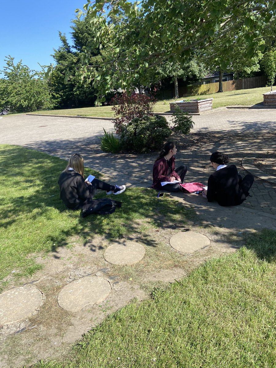 It’s far too hot to work in the classroom. Mrs Leven’s S3L class creating leaflets in the sun.
