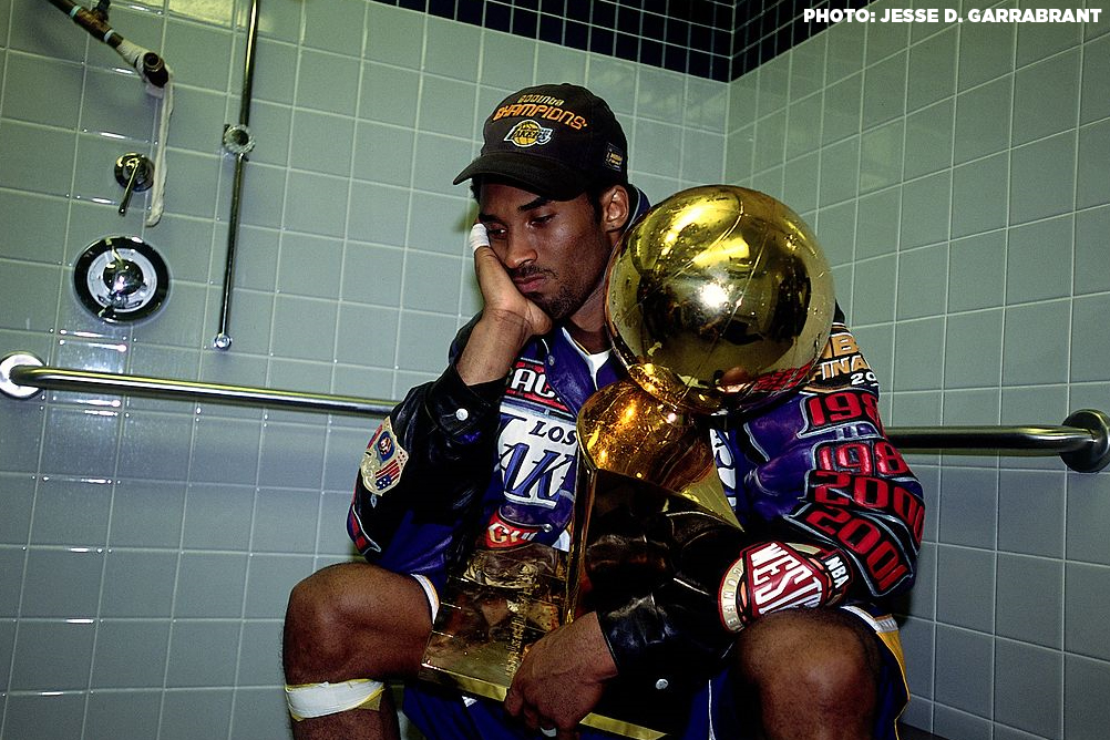 "That was about my Dad"
22 YEARS AGO TODAY: This iconic photo of Kobe after the Lakers went 15-1 in the Playoffs &amp; won the 2nd of 3 straight championships  

It was a bittersweet moment for Kobe because his parents didn't attend any of the 3 Finals games in his hometown of Philly