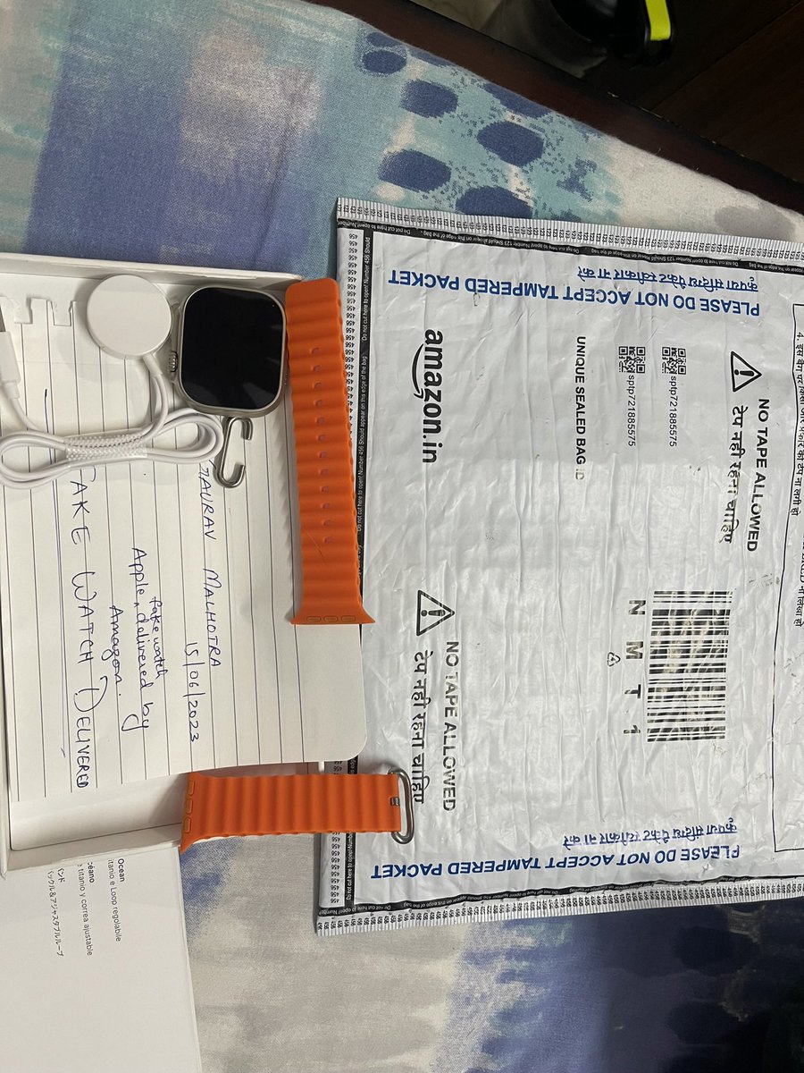 pupuldutta's tweet photo. Here is the media that clearly shows it’s fake! Apple does not have orange colour in ocean band, the charger is plastic, watch is plastic too #apple #fake #fraudalert @amazonIN https://t.co/MAirg4uLmn