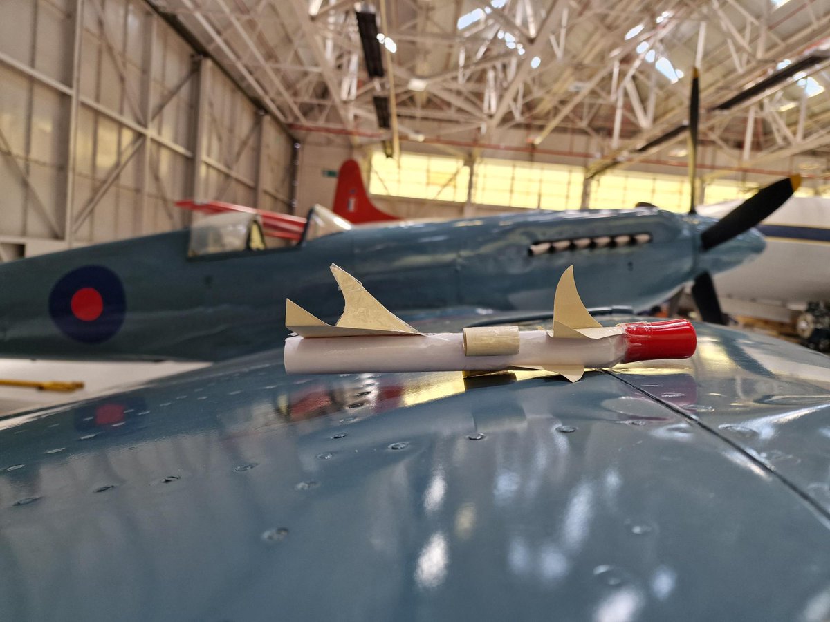 RAFMLearning's tweet photo. MIDS: Which is faster?🤔It's a close call between this rocket made by one of the students on our #STEM day today, and the Vickers Supermarine Spitfire PR. XIX, currently residing in Hangar 1! 🛩️🚀#Spitfire #CuratorsLookAway #RocketEnvy https://t.co/jamtZX7DLs