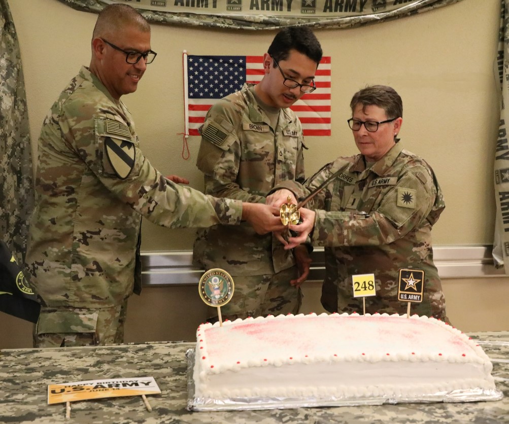 U.S. Army 40th ID Command Sgt. Maj. Refugio Rosas, Pfc. Bryson Brown, a signal support systems specialist, and Chief Warrant Officer 4 Theresa Torres, an information services technician, celebrates the Army’s 248th birthday by cutting a cake, June 14, 2023, at #FortCavazos, Texas