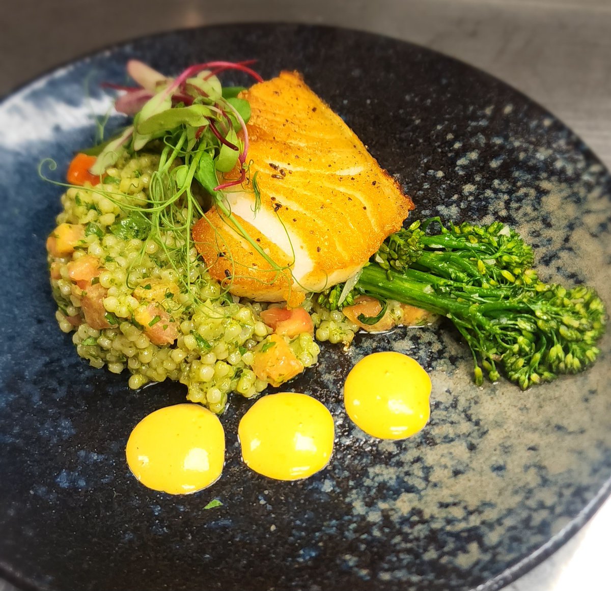 Get your tastebuds ready!. Chef Taylor's Chilean Sea Bass seared to perfection, accompanied by a fresh Tomato-Pesto Israeli Cous Cous and a Saffron-Red Pepper Aioli with grilled Broccolini. Be first in line when we open for dinner at 4:30pm today because this will not last long.