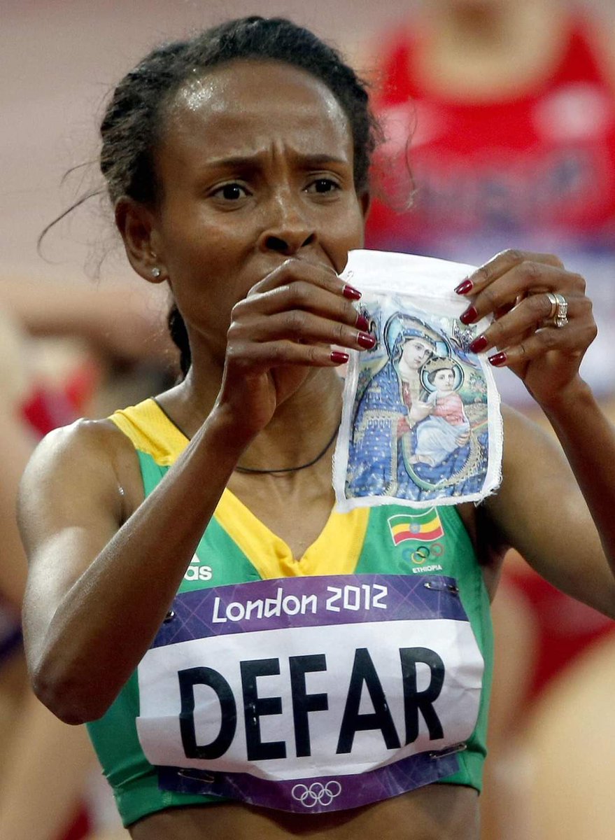 Sachinettiyil's tweet photo. After winning Gold medal in 5000 meter race at the London Olympics in 2012, Ethiopian athlete Meseret Defar pulled a cloth picture of the Virgin Mary from her track top and showed it to the cameras. https://t.co/xHZXXYYc13