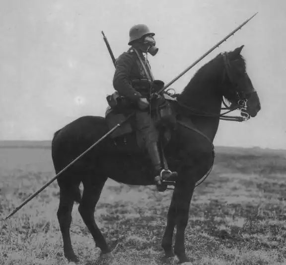 A German cavalryman patrolling behind the WW1 front lines in 1918, carrying a steel lance. German lances were hollow tubes made of rolled steel, typically consisting of three sections that were fitted together. They had a length of 3.2 meters and weighed 1.6 kg. When held at the…
