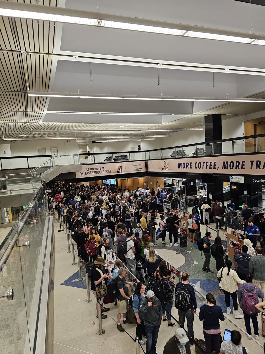 At SeaTac Airport. Checkpoint 3 with overflow going across Skybridge 3 into the parking garage at 9:40pm. Only 3 lanes running.