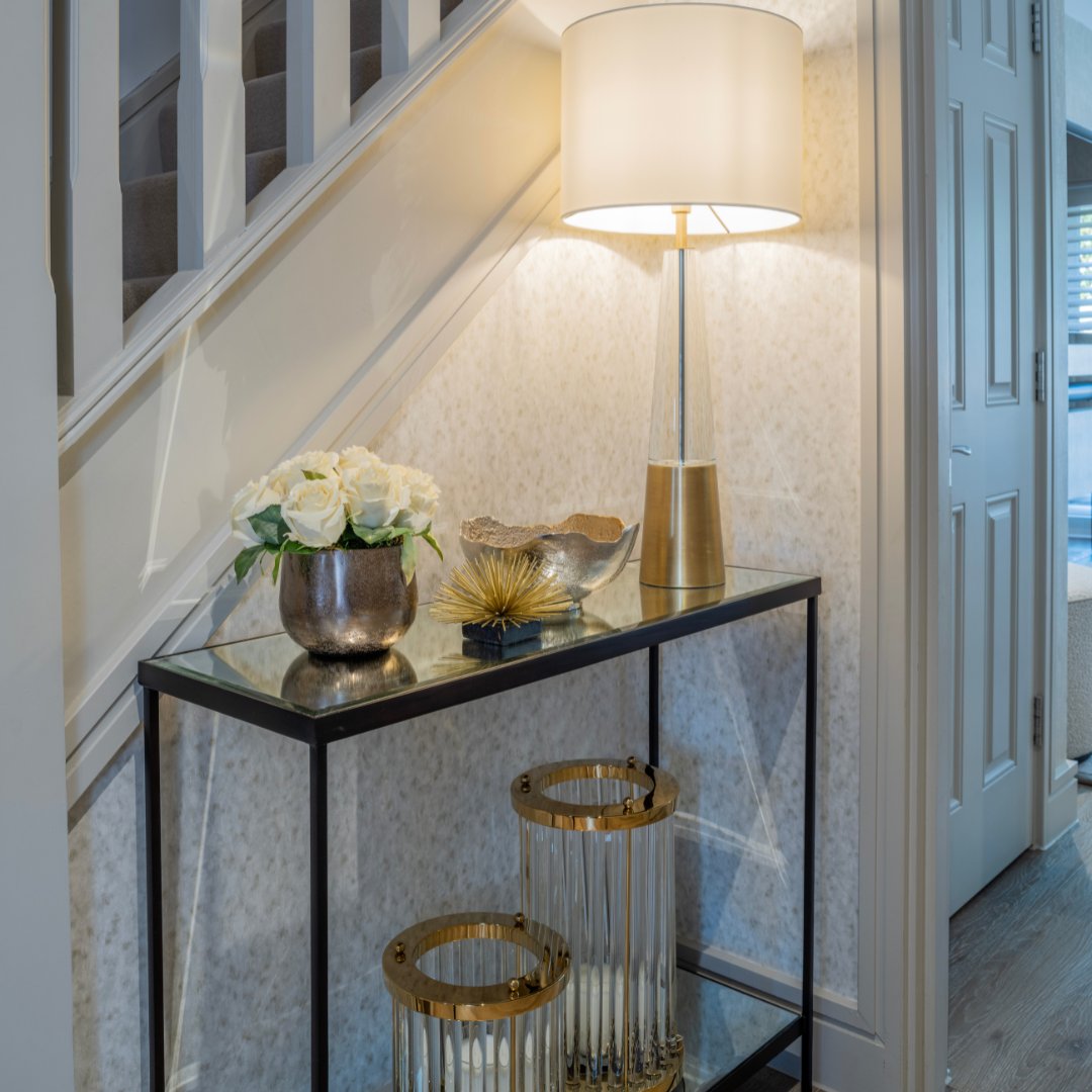 Wallpaper with  a subtly mottled pattern in neutral tones sits elegantly alongside a bronzed antique mirror console, working harmoniously to create the perfect entrance. 

#staircase #grandstaircase #dreamhomes #countryhomes