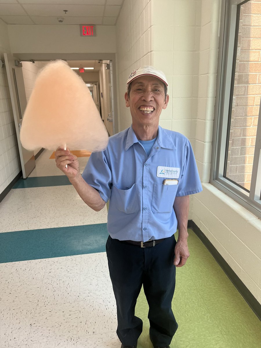 Mr. Dang enjoys cotton candy during the 5th grade celebration.