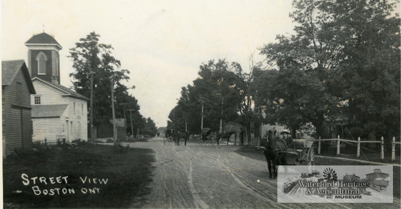 A throwback post of Boston Ont. featuring its Main Street (W2023.4.2). The General Store can be seen on the right side within the trees.