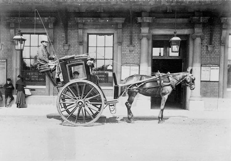 Thomas Tilling hansom cab at Greenwich station, 1884.  The hansom cab is a kind of horse-drawn carriage designed and patented in 1834 by the architect Joseph Hansom. The vehicle was developed and tested by Hansom in Hinckley, Leicestershire, England.