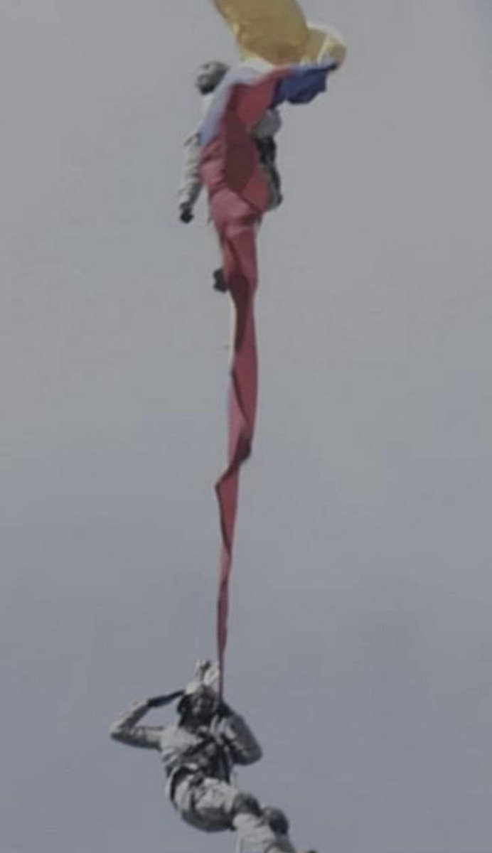 Colombian soldiers giving a final salute as they drop to their death. The rope that was carrying them suddenly broke during an airshow.