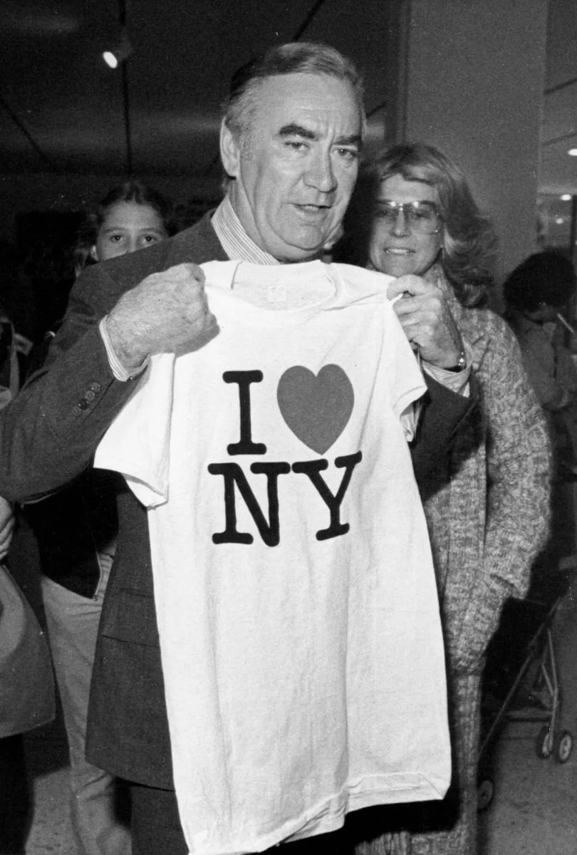 shirtsthtgohard's tweet photo. It’s one of the most iconic, most recognizable and most reproduced logos of all time. And it revitalized a city. In 1977, New York City was in decline. Its public perception was as a crime (and rat) infested dump. The New York State Department of Commerce sought to revitalize tourism through an advertising campaign. They needed a powerful graphic, something that would inspire positivity in inhabitants and attract tourists to its friendly streets.

The commission went to acclaimed graphic designer Milton Glaser. The story goes that Glaser, inspired by a conversation in a taxi cab, sketched his initial idea for the "I Love NY" logo with a red crayon on a ripped envelope (now stored at the MoMA). The design aligned with Glaser’s design philosophy, which prioritized simplicity above all else.

When it made its way onto a white T-shirt, it was an instant hit. The shirt sold by the thousands. It immediately became a must-buy for tourists to purchase on their trip to the big apple. If you went to New York and didn’t buy one, did you even go? The campaign was initially intended to last for a few short weeks. Instead, the icon bedecks the shirts, hats, and coffee mugs of souvenir shops across the five boroughs more than four decades later. Glaser gave the logo rights to New York for free. Yet the state has also filed more than 3,000 Trademark complaints for unlicensed use of the logo. Still, it’s hard to follow up with every cease and desist in the bootleg T-shirt capital of the world.

Upon its debut, the campaign exceeded all expectations, quickly capturing the hearts and minds of people from all walks of life. The campaign was only supposed to last a few weeks, but was extended for years. The "I Love NY" logo became an instant sensation, adorning billboards, buses, and brochures across the city. However, it was the "I Love NY" T-shirt that truly propelled the campaign to unprecedented heights.

Tourists and locals alike embraced the T-shirt with fervor, proudly displaying their affection for the city they adored. It quickly transformed into a powerful symbol of unity, warmth, and resilience, particularly in the face of New York City's challenges. The T-shirt's universal appeal transcended language barriers, resonating with individuals worldwide and igniting a sense of connection to the vibrant metropolis.

The "I Love NY" T-shirt endures as an iconic symbol of love, pride, and unity for New York City. It serves as a remarkable testament to the creative genius of Milton Glaser, and has solidified itself into popular culture.