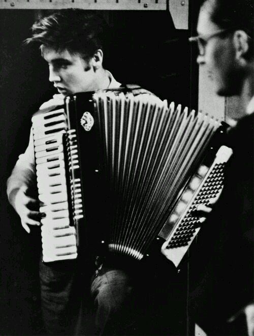 June 30, #Elvis1956 
Elvis is photographed playing an accordion to relax while answering questions from a local reporter after a performance at the Mosque Theatre in Richmond, Virginia. Photo credit: Alfred Wertheimer 
 #ElvisHistory 
#Elvis2023 
#ElvisPresley