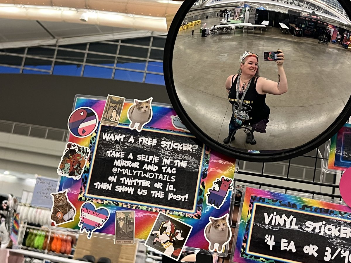 All set up at Anthrocon and READY to see all my friends and make new ones! This is the biggest table we’ve ever done, I worked my tails off handmaking over -a thousand- original things!!

And visit the selfie mirror to get a weird sticker!