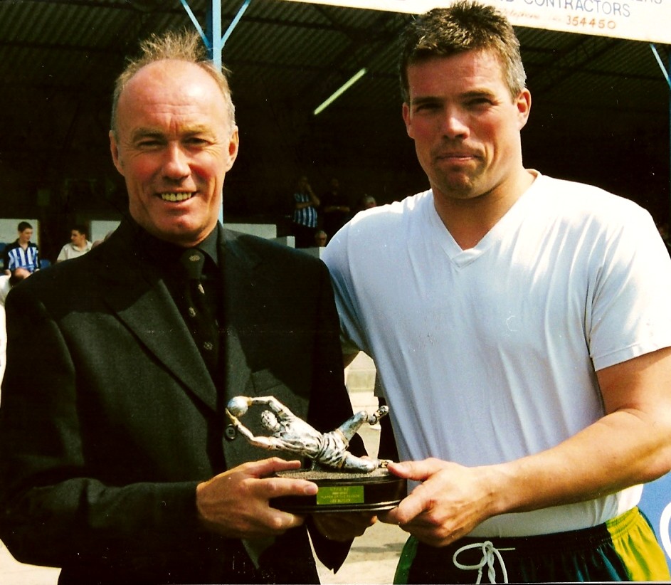 Halifax Town goalkeeper Lee Butler receives the Player of the Year award for 1999/2000 from visiting manager Sammy McIlroy. 📷Keith Middleton.