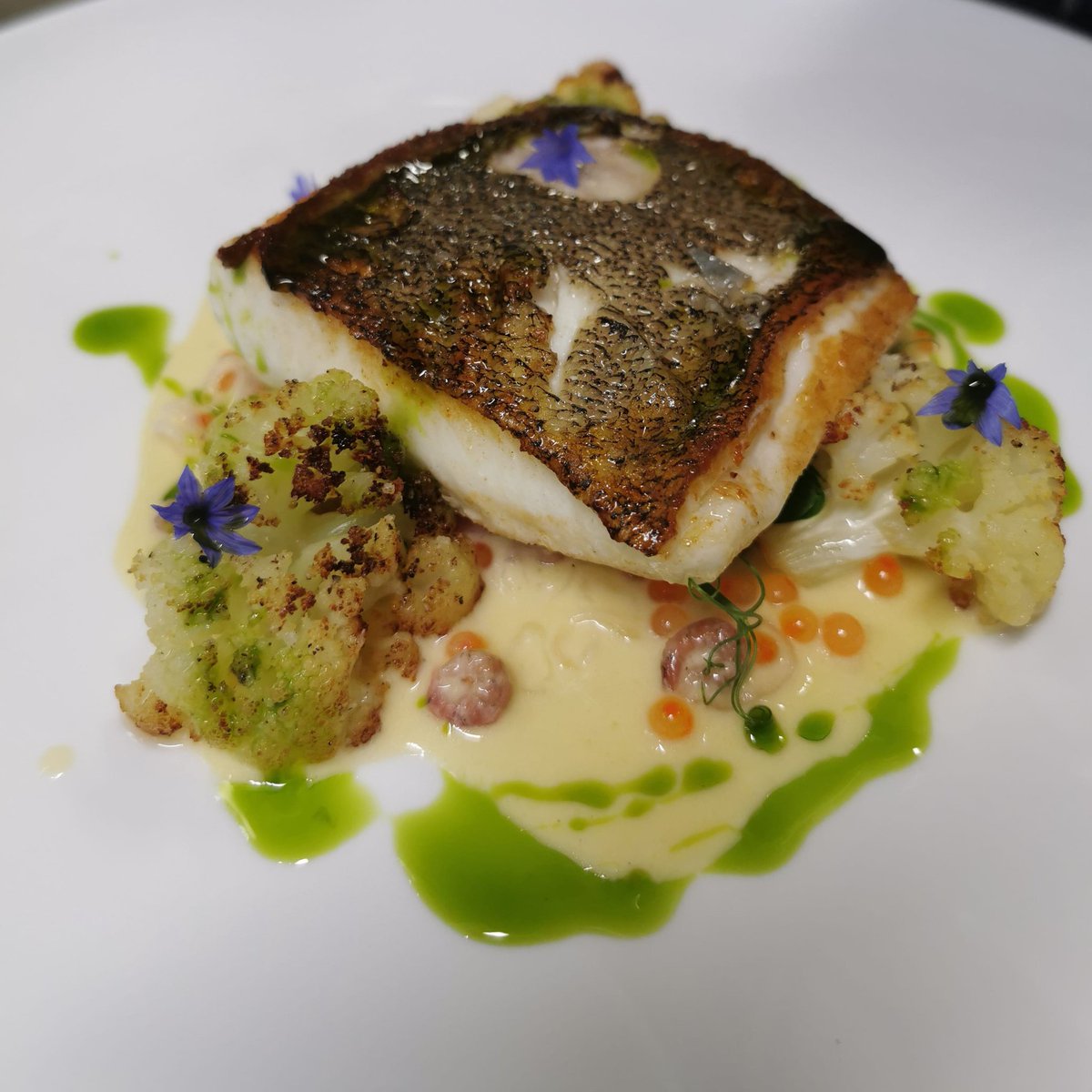 Pan roast wild Halibut, roast cauliflower, herb confit potato, shellfish beurre blanc &amp; trout roe.
