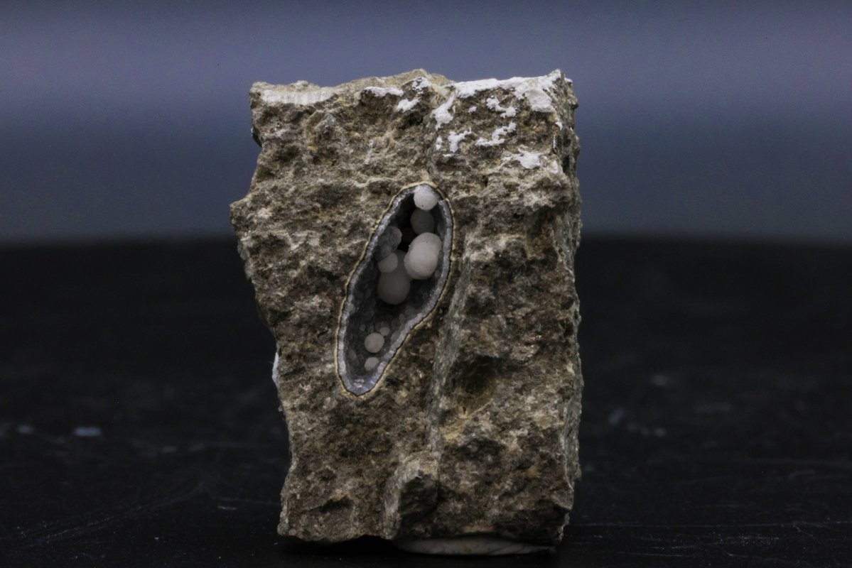 This rare mineral, named after amateur mineralogist Ralph Cowles, is found in volcanic rocks and metamorphic environments. With its delicate bluish-green hue and intricate spherical crystal formations, cowlesite showcases the dynamic processes of hydrothermal alteration.