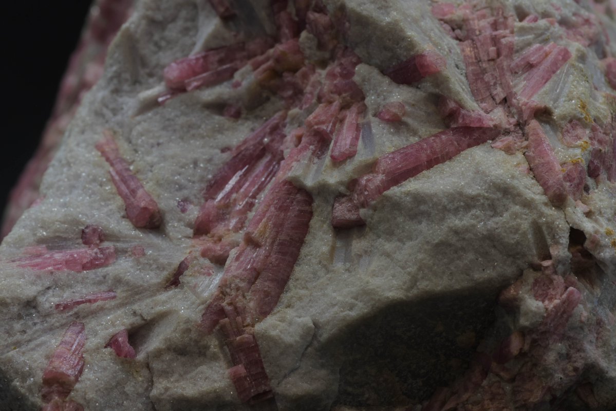 Decode the wonders of tourmaline! This remarkable gemstone most often forms in pegmatitic igneous rocks. Its unique crystal structure allows it to harbor a dazzling array of colors, thanks to elements like iron, manganese, and lithium. Pink tourmaline is also known as rubellite.