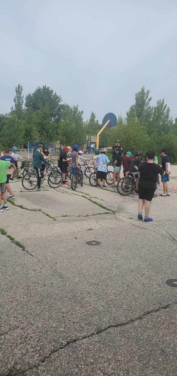 The grade 5/6 and 6/7 classes have fun while learning about bike safety from Constable Darrell of the Winnipeg Police Service.
