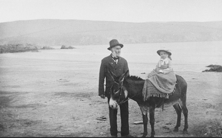 Mothecombe Beach, 1880. Miss Beatrice Mildmay, on her donkey led by old retired sailor called Burch who lived in Mothecombe.
