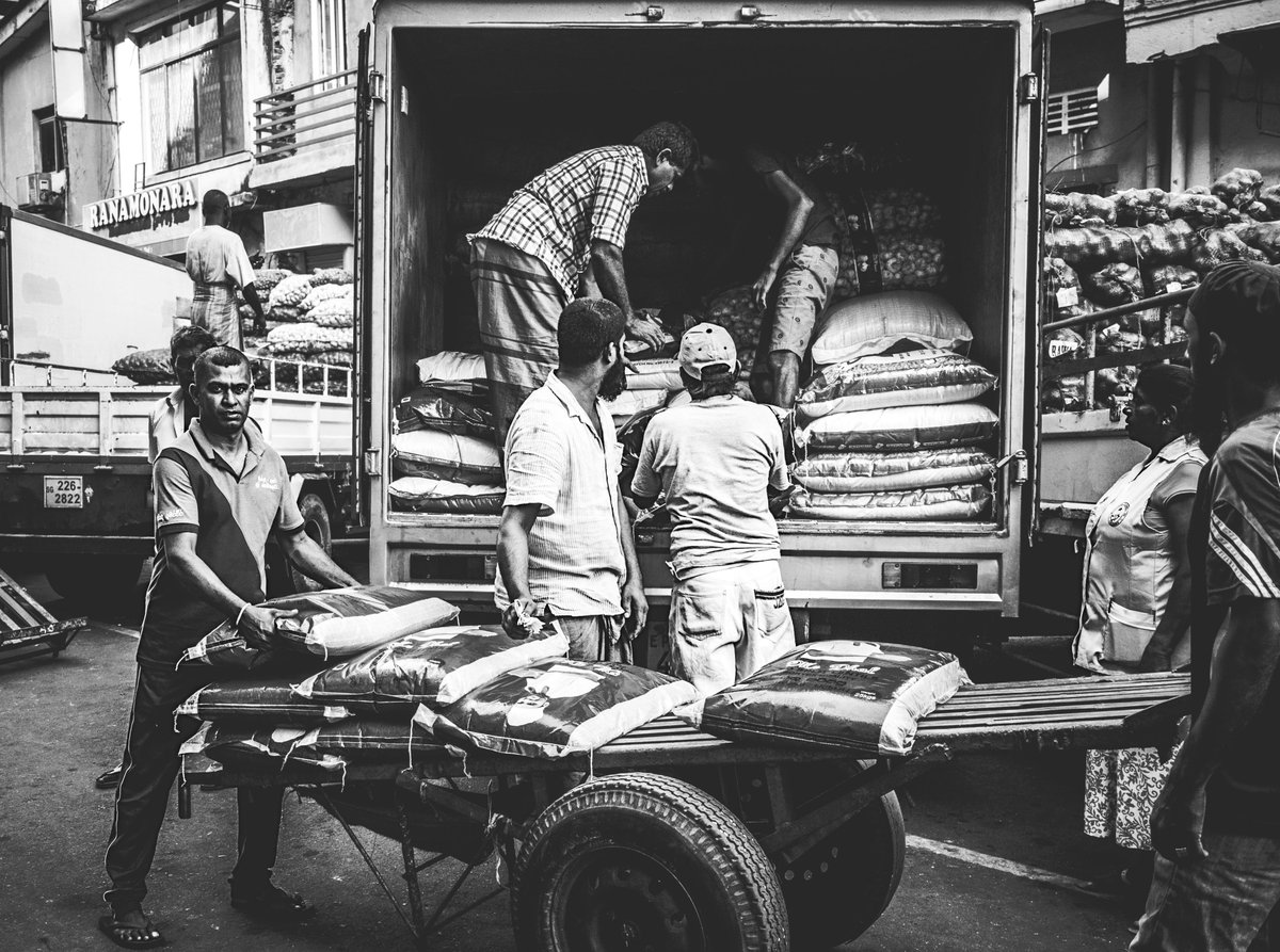 S_MorningLight's tweet photo. PARIPPU DROP
A #naattami loads his distinctive 2-wheeled cart with sacks of lentils trucked in from a mill outside #Colombo. Keyzer St, Jan 2020... [see comments] More@ https://t.co/S7PijvVKmp
#blackandwhitephotography #streetphotography #pettah #SriLanka #lifeinthecity #urban https://t.co/FjpXkrfEJa