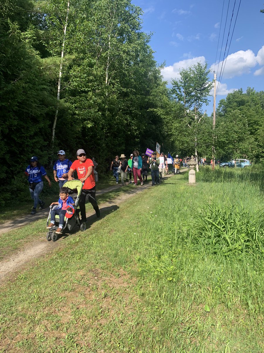 Macdonald2Laura's tweet photo. Marchers reach Roxham Road after 3 day hike to protest the closure of the border to people seeking refuge from danger and oppression https://t.co/W43l6vYwSw