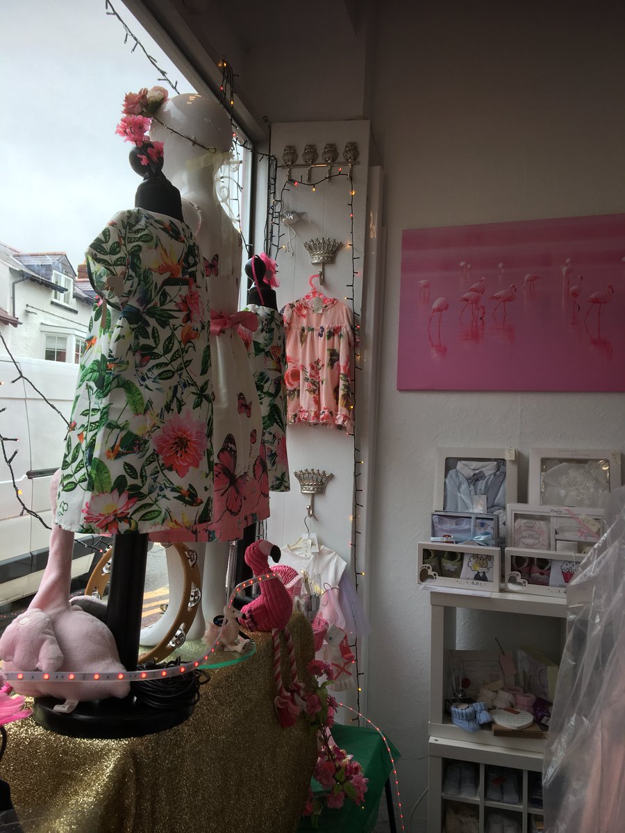 The window is now displaying 'The Flamingos at Glasto', no ticket required! Celebrate the summer solstice with a flowery dress for your little one. Open 9-4 Tues, Fri and Sat.#abergele#shoplocal #Glastonbury #SummerSolstice