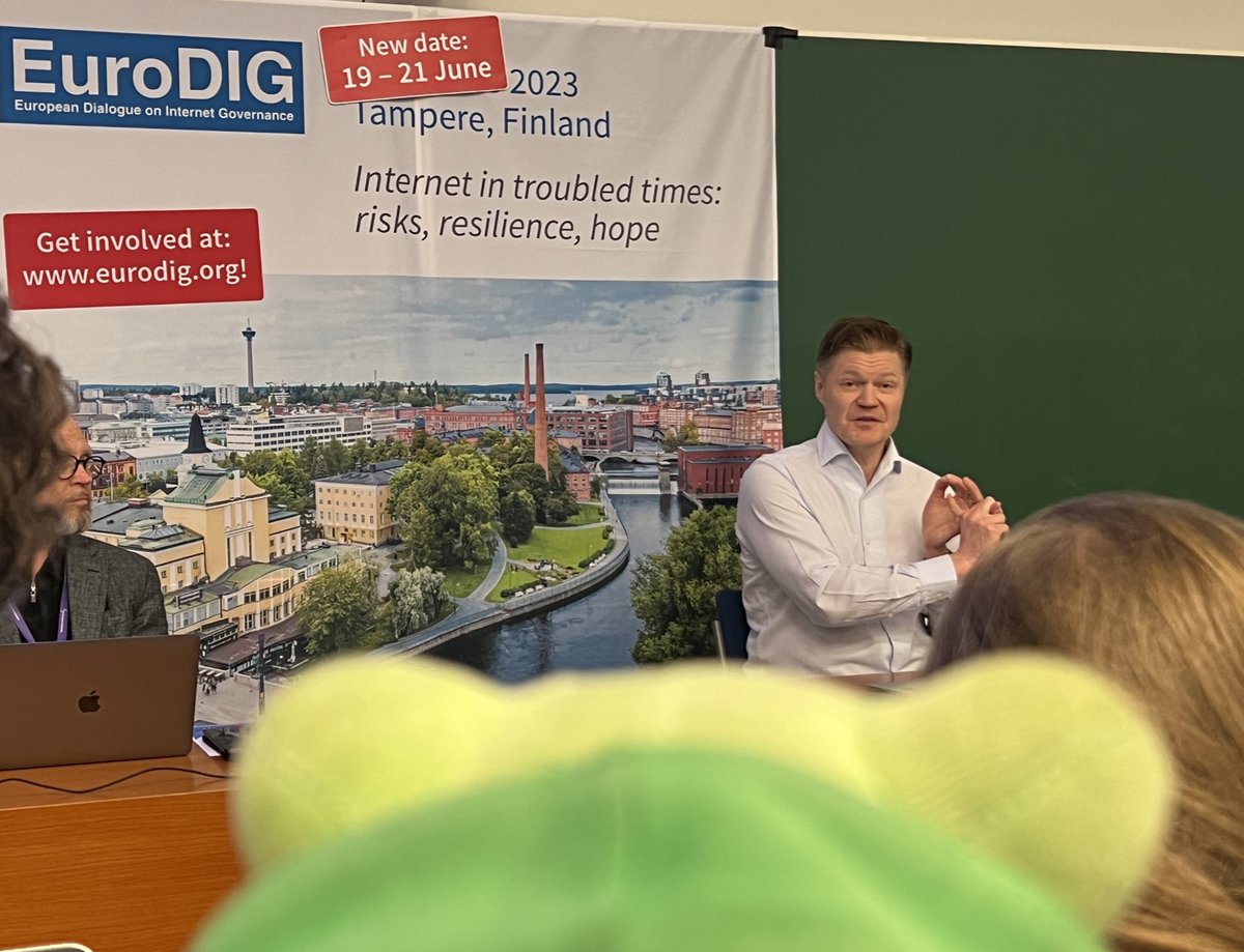 Samu the digital rights frog is listening to stuff about digital information literacy. Humans have these dreadfully complicated things, but a small frog tries to get it #EuroDIG2023