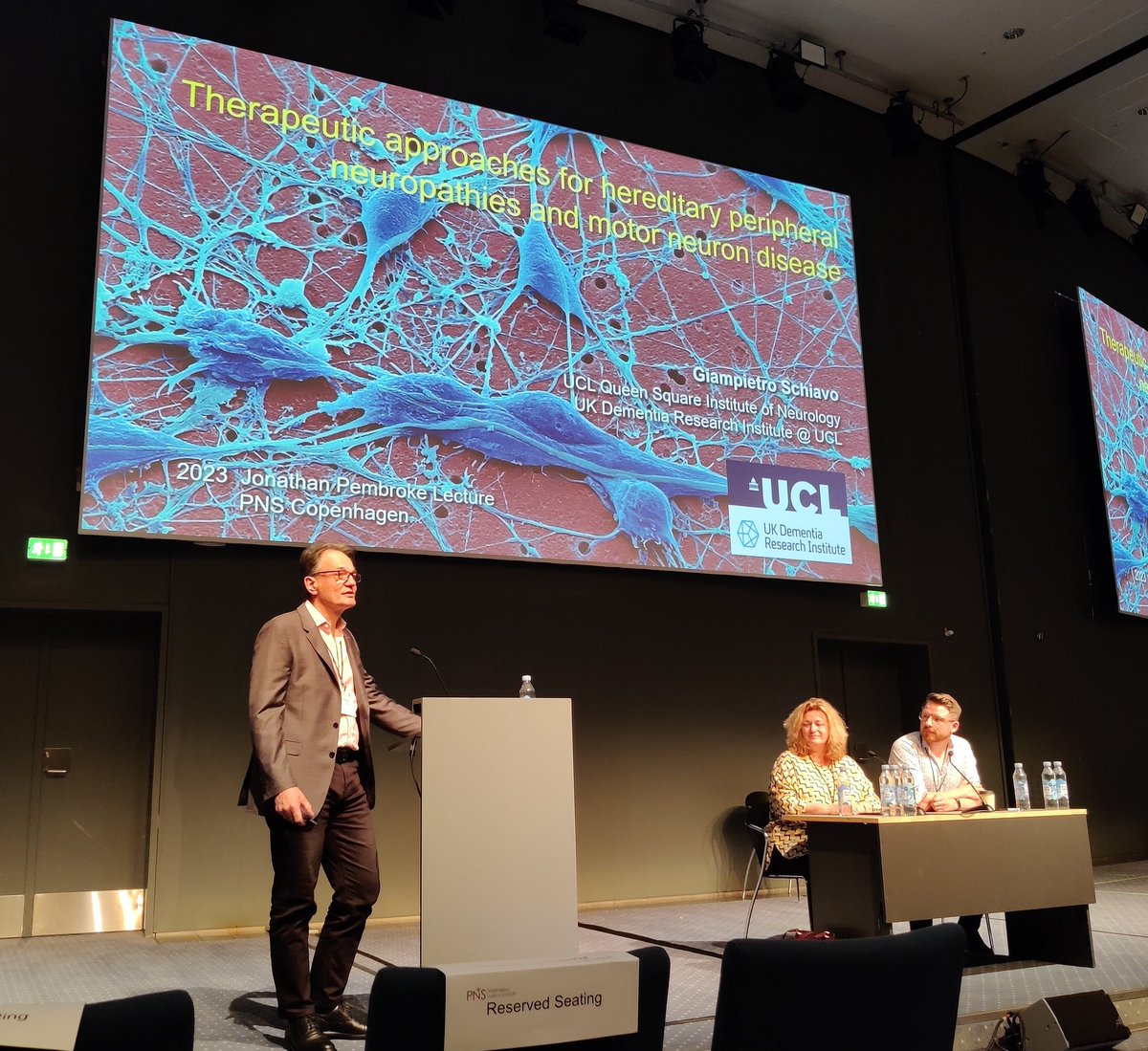 DrBiol's tweet photo. Giampietro Schiavo @UCL_QS_CNMD delivers 2023 Jonathan Pembroke Lecture @pnsociety1 conference in Copenhagen.
Including great work to understand #CMT2D from @J_N_Slayer lab that will help identify targets for treatment.
#PNS2023 #CMTresearch https://t.co/loC39tlpuL
