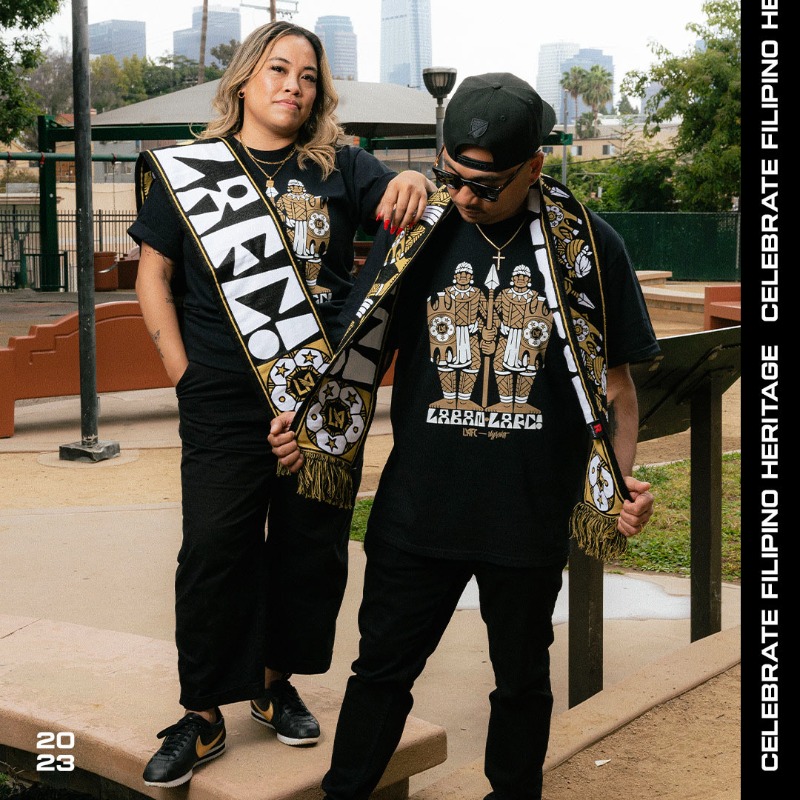 LAFC's tweet photo. Celebrate Filipino Heritage Night with us this Wednesday @BMOStadium, featuring a limited edition merch collection designed by artist D.J. Javier. 

🇵🇭📸 Black &amp; Gold Filipino group Isang Bayan LAFC.