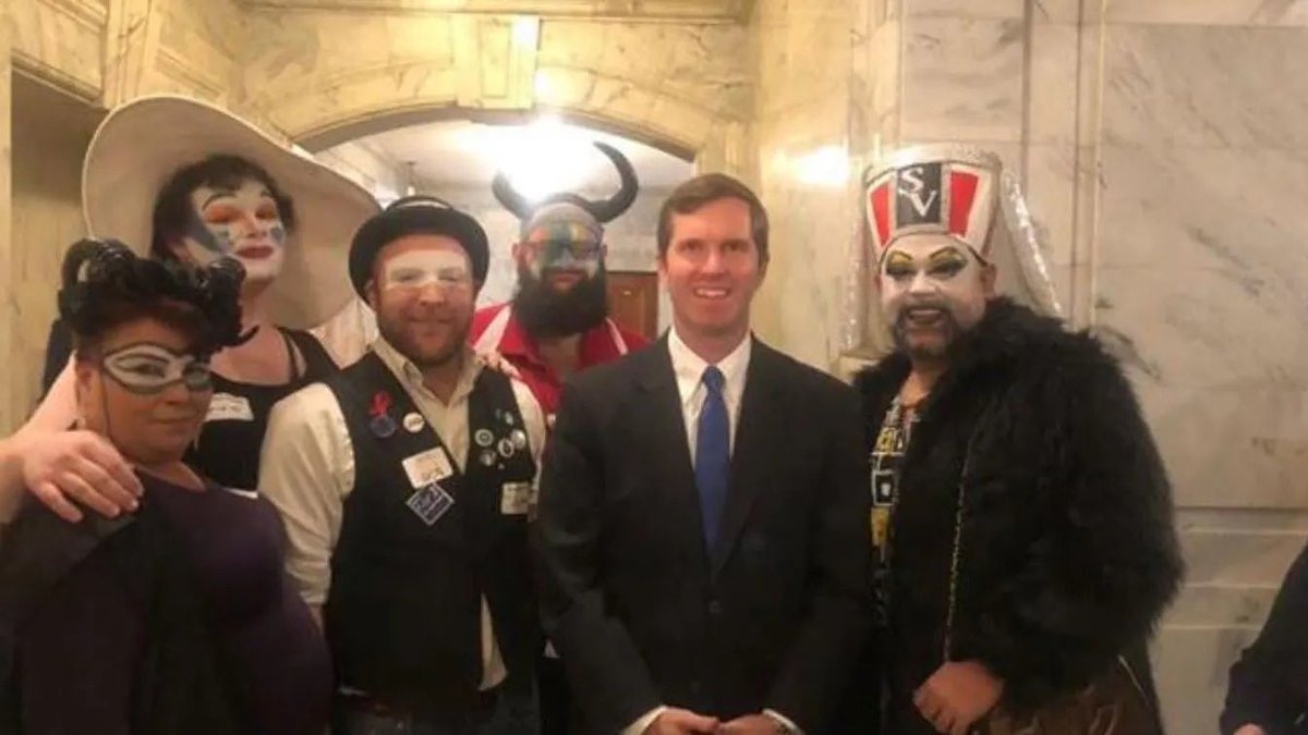 👀

Democratic Kentucky Gov. Andy Beshear appears in a heavily scrutinized photo with a local chapter of the anti-Christian Sisters of Perpetual Indulgence, the Derby City Sisters, during a pro-LGBTQ event in February 2020. (Derby City Sisters)
