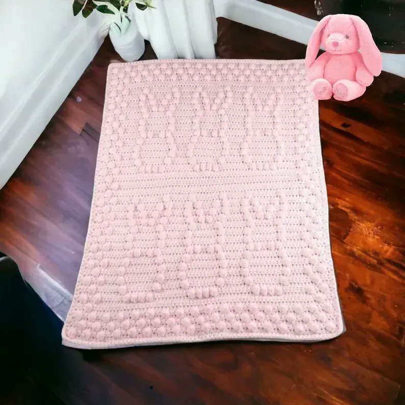 Crochet baby blanket in pink with puff bobbly bunny pattern buff.ly/3pw648J #knittingtopia #etsy #babyblanket #bunnyblanket #baby #mummybloggers #crochet #tweetuk #newbaby #newmum #reborndollcommunity #MHHSBD #craftbizparty