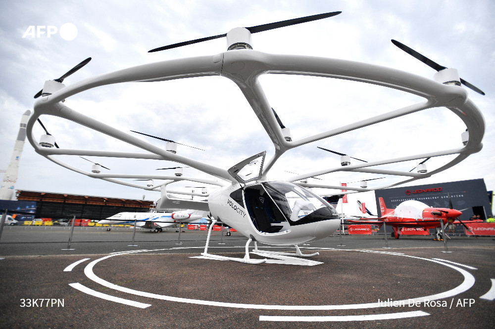 AFP's tweet photo. Barely making a buzz, a two-seat helicopter powered by an electric battery lands softly on the tarmac at the Paris Air Show.

"Flying taxis" are among the stars of the major aerospace industry event, as they move closer to being approved for public use.

https://t.co/lsp265XxJb https://t.co/uT0d1qeQOd