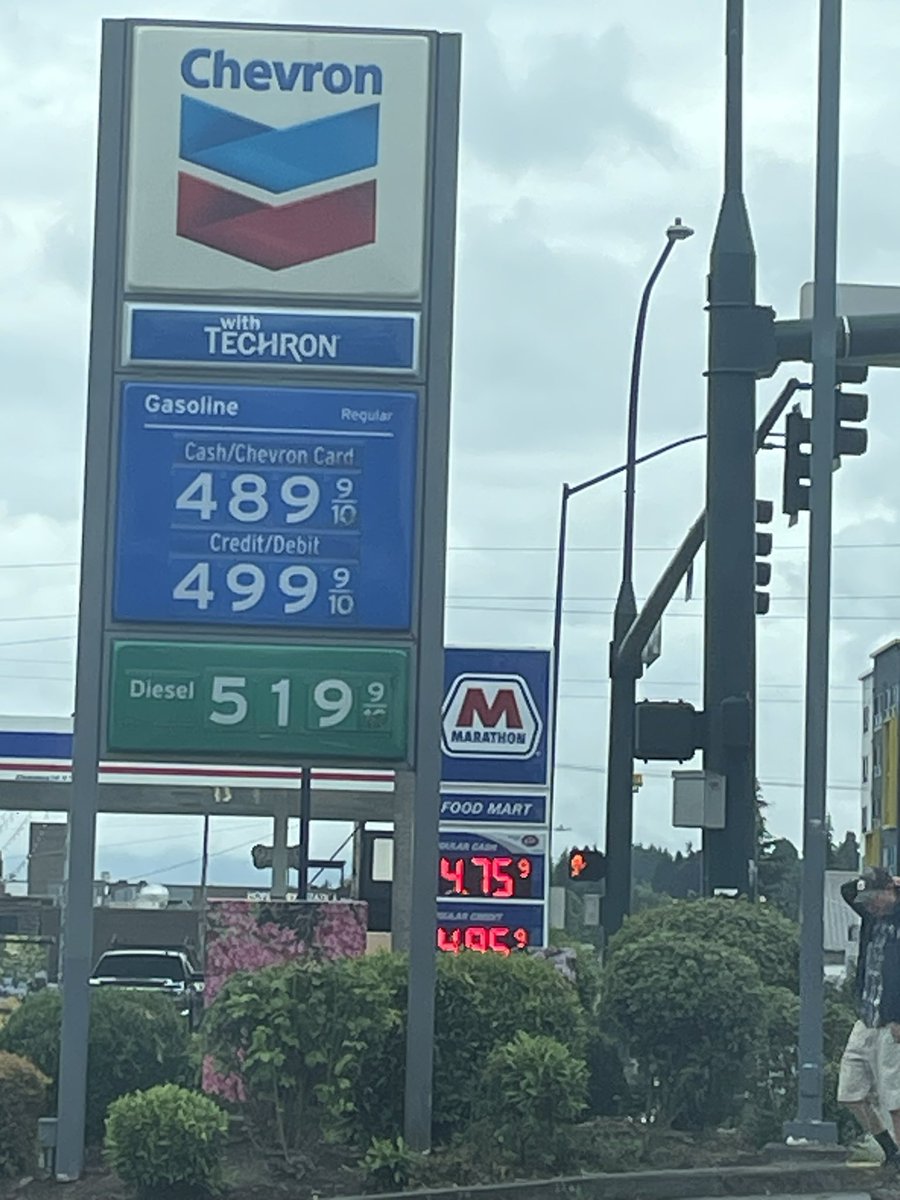 Kattressa's tweet image. I did it. I found gas prices less than $5/gallon.

Granted, this is in #Everett, and Snohomish county hasn’t felt the surge the same as King Co. But I’m counting it as a win.

And I purposely photographed both signs in there. The Marathon station is $4.75 cash $4.85 card.