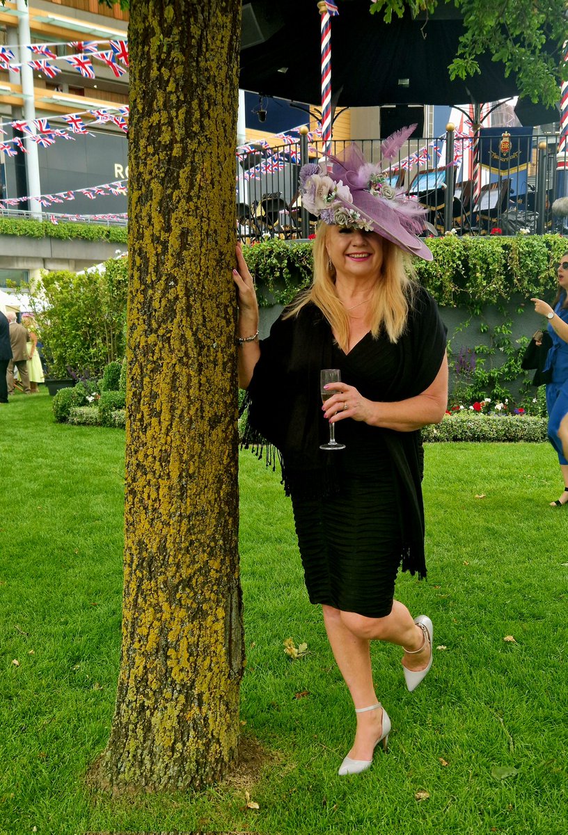 A glass of Champagne in one hand and a tree trunk in the other that's @RoyalAscotSite #RoyalAscot2023 #hats #fascinators #trees #horseracing