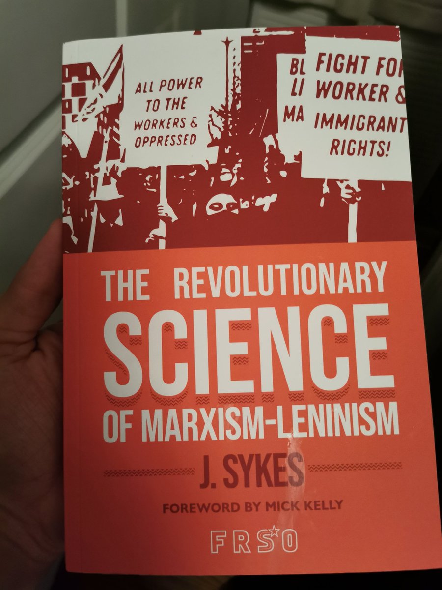 A hand holding a book titled The Revolutionary Science of Marxism Leninism by J Sykes, published by FRSO with a forward by Mick Kelly 
