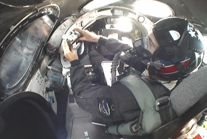Cockpit of SpaceShipOne in space with pilot taking a picture out a window