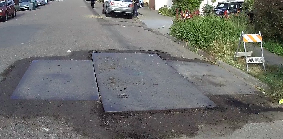 drmickp's tweet image. Steel plates sticking up over 1", and poor trench backfill with over 1" drop at the margins. This is on a signed bike route, and poses a serious hazard to users of that route. Is this your work, @MillerPipeline? Do better, before you get sued to cover someone's medical expenses.