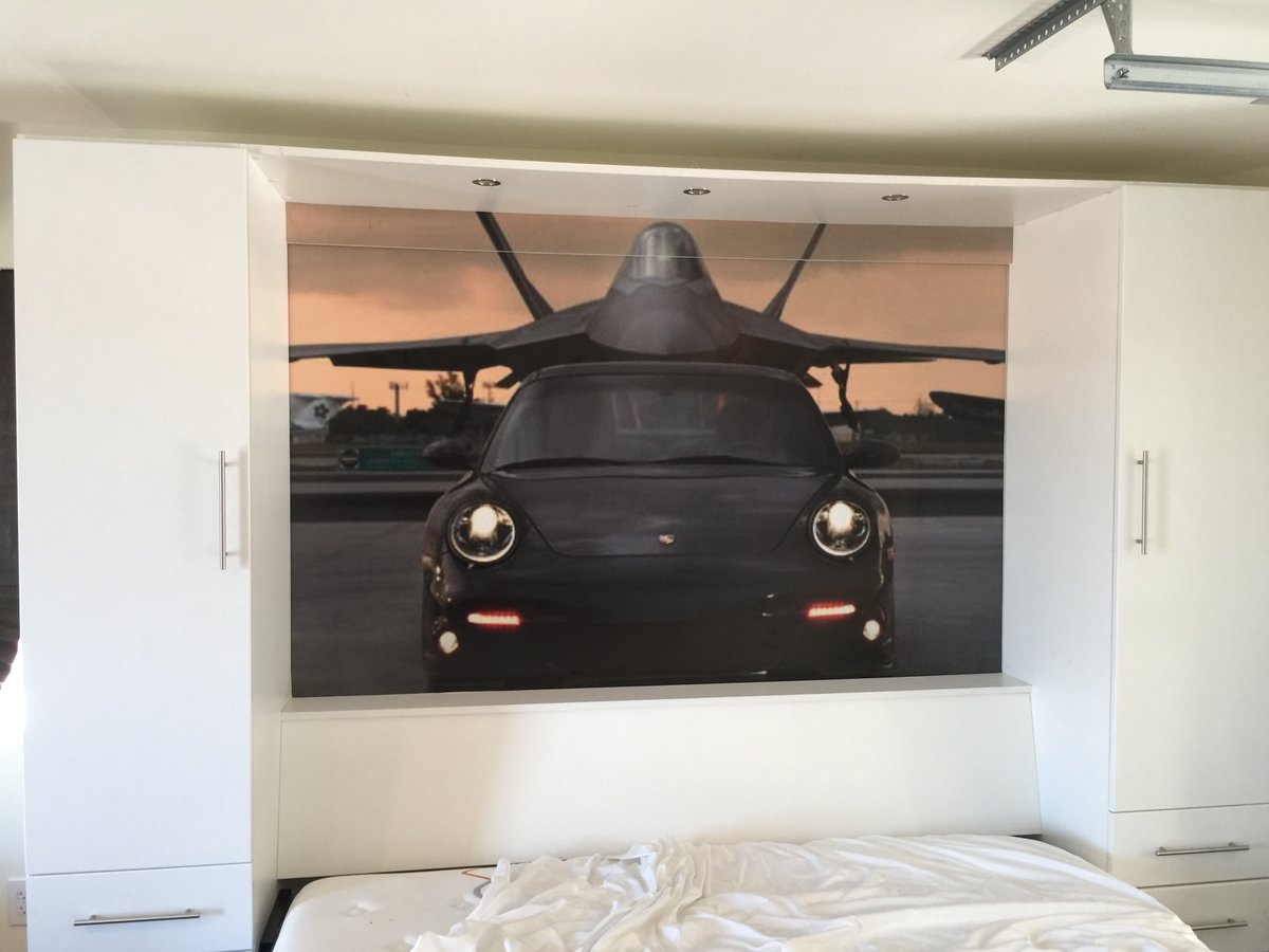 Transform any space with vinyl #wallwraps by #designerwraps. Here's a throwback to a Porsche inspired mancave project including the hidden murphy bed wrap. We've always got you covered! #wallcovering #wallwrap #wallmural #vinylwrap #largeformat #wrapdesign #designisinourname