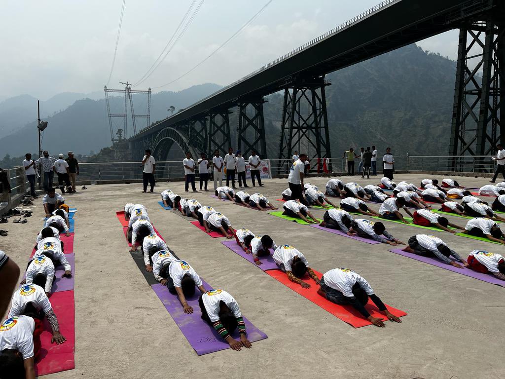 Yoga performed at the world's highest Railway Bridge at Bakkal/Kouri by the department of youth services and sports district Reasi.

#TYPNews