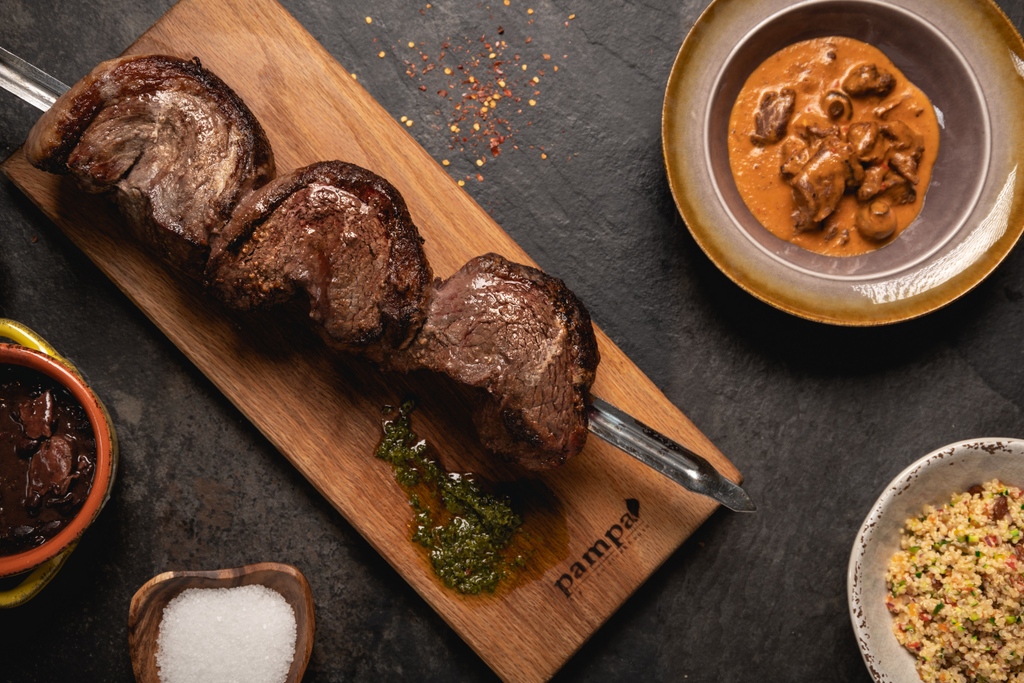 Join us in giving a warm welcome back to <a href="/EatPampa/">Pampa Steakhouse</a>! Experience the unique Rodizio dining style, where you can indulge in a wide variety of salads, hot dishes, and ten mouthwatering cuts of meat from the Brazilian rotisserie grills, accompanied by caramelized pineapple.