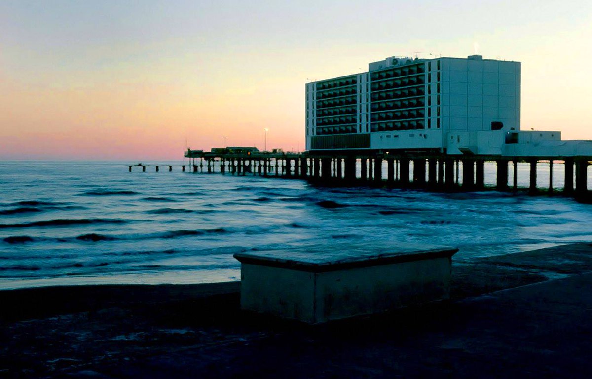 The  Flagship Hotel in Galveston, 1980.  How many of y'all ever stayed here  or drank in the bar?  As far as I know, this is the only hotel in  history to have been erected out over the ocean like this. It was built  in 1965 but had to close in 2008 after Hurricane Ike heavily
