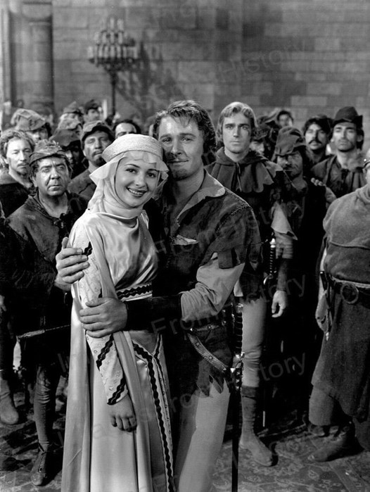 ERROL FLYNN, here w/ Olivia de Havilland &amp; the Merry Men on the Robin Hood set. Read all about all the shenanigans off-screen in my book, "ERROL, OLIVIA &amp; THE MERRY MEN OF SHERWOOD

US amzn.to/2RQ5mPj
UK amzn.to/2GrBx2l
Canada: amzn.to/2vg4X0T

#TCMParty