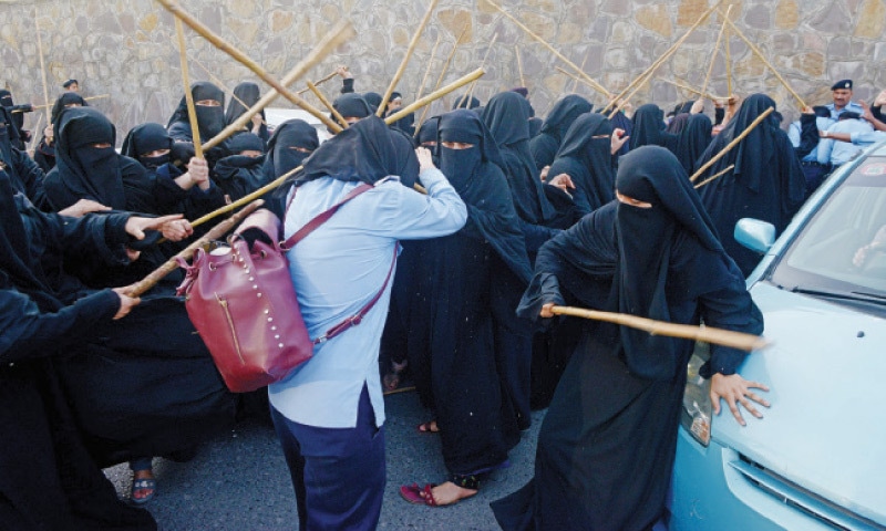 Students of the seminary Jamia Hafsa beat a policewoman of the Islamabad police with sticks on Wednesday - the day saw Maulana Abdul Aziz emerge and lead prayers at Lal Masjid despite a ban on him by the government and his replacement as khateeb

Pic via Mohammad Asim for Dawn