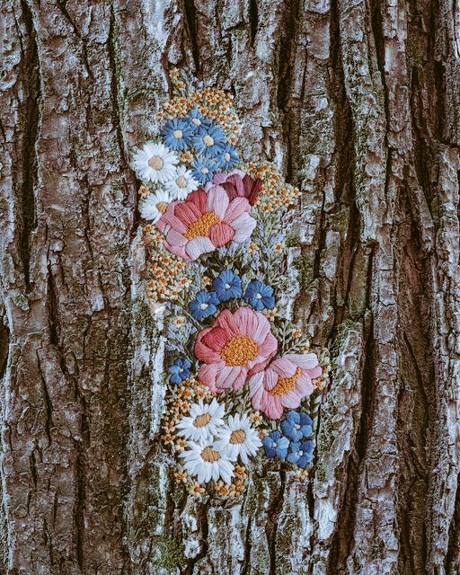 Ukrainian artist Diana Yevtukh often displays her embroidered textile art within nature, such as placing her pieces on trees #WomensArt