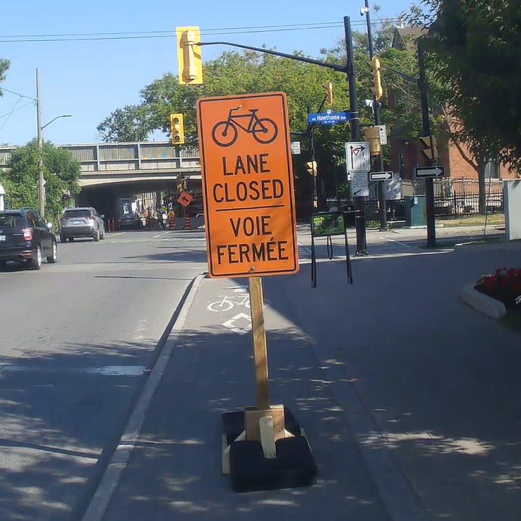 After the #ottwalk-#ottroll-#ottbike rally for safe streets, I went to pick up some pastries at Tartelette. On my way back up Main St. I encountered this misplaced sign in the middle of the lane a full block before the closure.