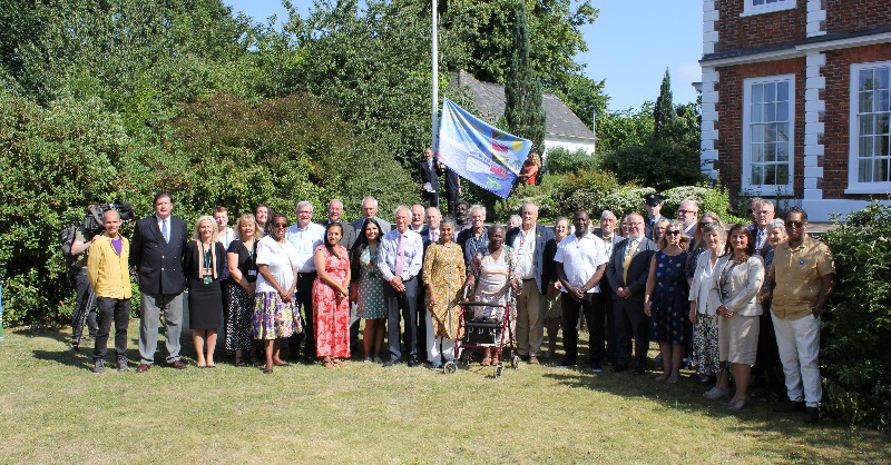 DevonCC's tweet photo. The Devon Windrush Flag was raised at County Hall today to mark 75 years since the Empire Windrush arrived in Tilbury Dock in a symbolic moment for Britain.

#Windrush75 🧡